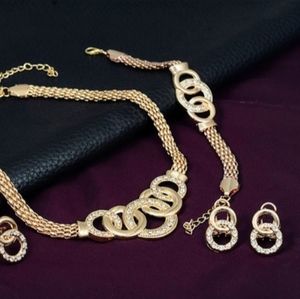 Gold colored interwoven ring jewelry set.